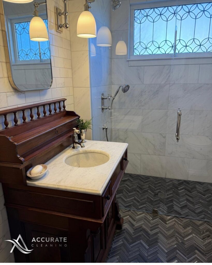 Clean bathroom vanity and tiled walk-in shower